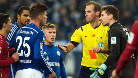 Klaas-Jan Huntelaar (number 25) is shown a red card