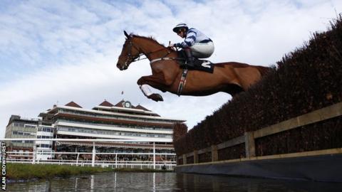 Jockey Jamie Moore riding Top Gamble clears the water jump at Newbury racecourse