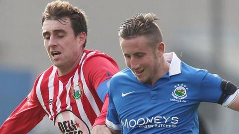 John Boyle of Warrenpoint in action against Linfield's Michael Carvill