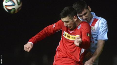 Cliftonville striker Joe Gormley and Ballymena's Davy Munster contest a high ball