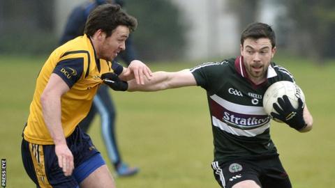 St Mary's Aidan Corker attempts to fend off DCU's Conor Moynagh in Belfast