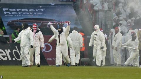 Fans on Borussia Moenchengladbach pitch