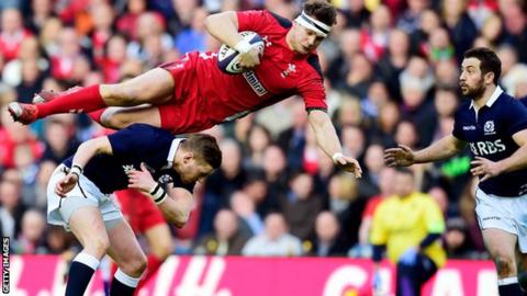Dan Biggar is sent flying by his opposite number Finn Russell
