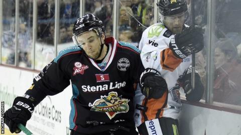 Giants forward Darryl Lloyd puts in a strong challenge on Sheffield's Tomas Petruska