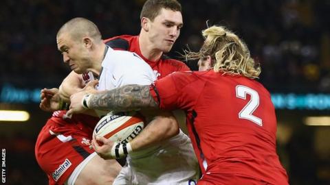 England full-back Mike Brown is tackled by Wales' George North and Richard Hibbard (right)