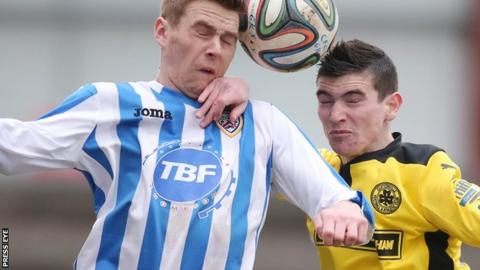 Coleraine striker Ian Parkhill in an aerial duel with Caoimhin Bonner