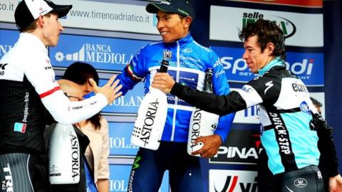 Nairo Quintana (C) of the Movistar Team is congratulated by second placed Dutch rider Bauke Mollema (L) of the Trek Factory Racing team and third placed Colombian rider Rigoberto Uran