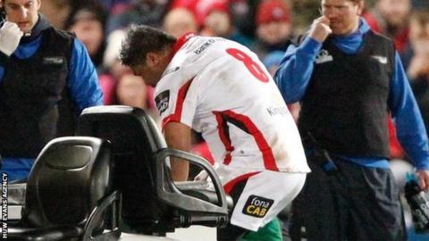 Nick Williams talks to Rhys Patchell while the player is on the medi-cart