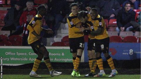 Newport County players celebrate after taking the lead at Accrington Stanley
