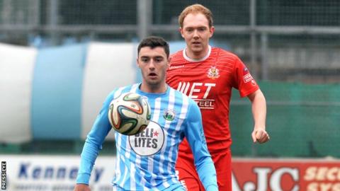 John McGuigan battles with Portadown's Ross Redman at Milltown