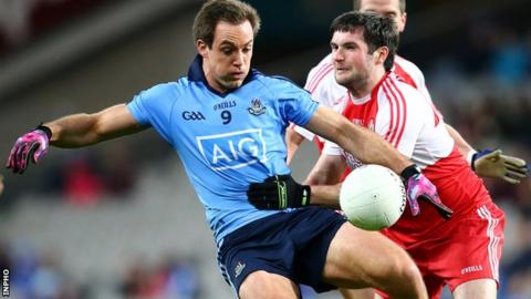 Dublin's Tomas Brady is challenged by Derry's Oisin Duffy