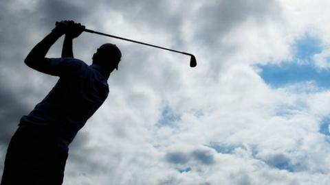 Silhouette of golfer