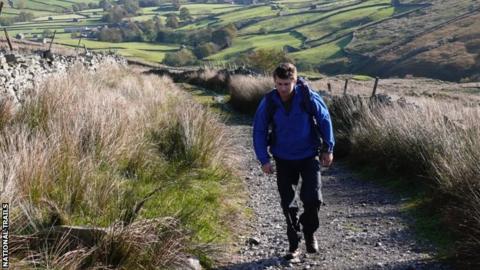 Man walking along a Pennine Way trail