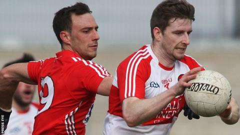 Paddy Kelly of Cork closes in on Derry's Niall Holly