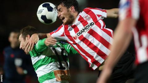Patrick Gregg of Shamrock Rovers is beaten to the high ball by Derry's Philip Lowry