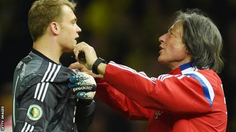 Hans-Wilhelm Mueller-Wohlfahrt treating goalkeeper Manuel Neuer