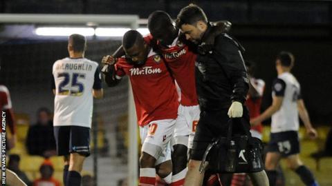 Ismail Yakubu is helped off the field in the 2-0 defeat against Southend United at Roots Hall