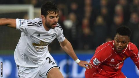Jordi Amat (left) challenges Daniel Sturridge