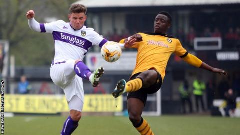 David Tutonda of Newport County challenges Alex McDonald of Oxford United