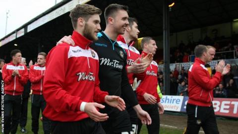 Newport County's players applaud their supporters after the Oxford game