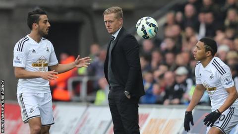 Swansea's manager Garry Monk looks on as Neil Taylor and Jefferson Montero restart from a throw-in against Stoke