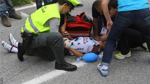 Italian rider Domenico Pozzovivo receives medical treatment after his fall during the third stage of the 98th Giro d"Italia