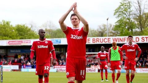 Crawley Town midfielder Josh Simpson applauds fans