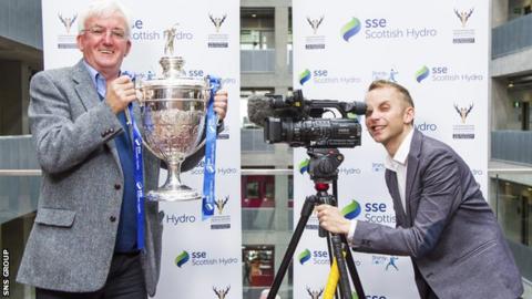 BBC Alba'€™s shinty presenter, Hugh Dan MacLennan (left) joins BBC Scotland shinty presenter, Jonathan Sutherland as they draw the Quarter-Final of the SSE Scottish Hydro Camanachd Cup