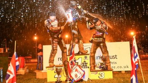British champion Tai Woffinden is sprayed on the rostrum at Monmore by Craig Cook and Danny King