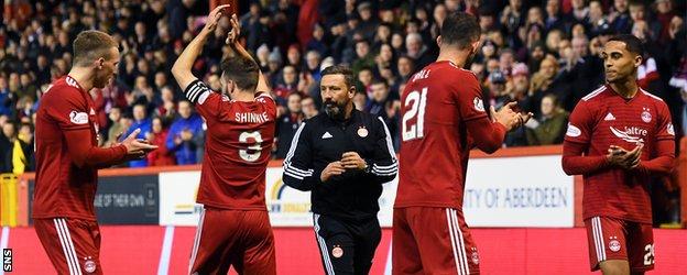 Graeme Shinnie, second left, made his final Aberdeen appearance at Pittodrie