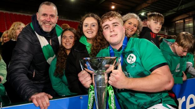 Scott Wilson celebrates winning the Under-20 Six Nations in 2022 wit his family and friends