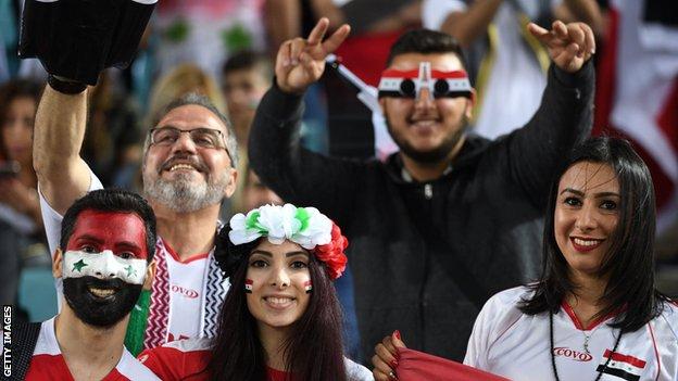 Syrian fans cheer for their team prior to the 2018 World Cup football qualifying match on October 10