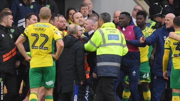 Players and officials arguing during Norwich v Ipswich