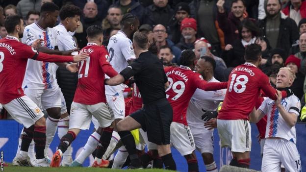 Casemiro of Manchester United grabs Will Hughes of Crystal Palace leading to a red card while players from both teams tussle during the Premier League match between Manchester United and Crystal Palace at Old Trafford on February 4, 2023