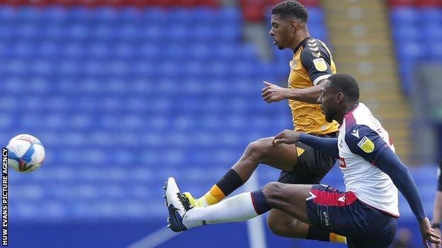 Tristan Abrahams in action against Bolton's George Taft