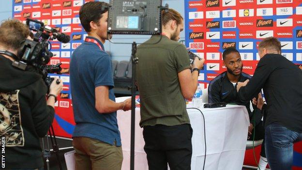 Raheem Sterling answers questions during an England open media session