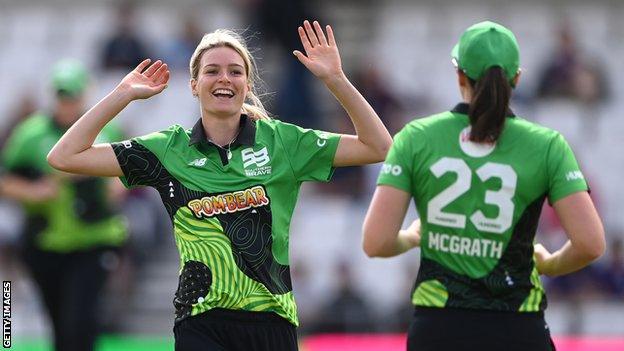 Southern Brave bowler Emily Bell (left) celebrates a wicket with team-mate Tahlia McGrath (right)