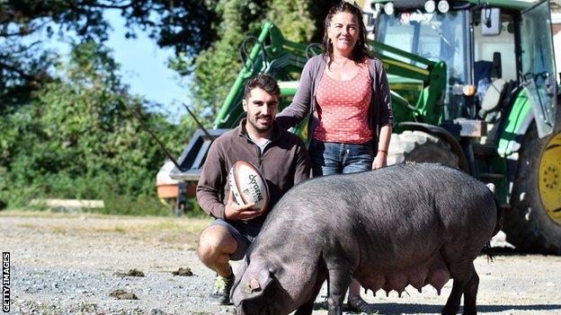 Clement and Marie-Pierre Dupont pictured with a rugby ball and a pig