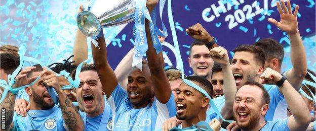 Manchester City celebrate with the Premier League trophy