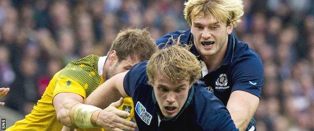 Jonny Gray (centre) takes on Australia's defence with support from brother Richie (right)
