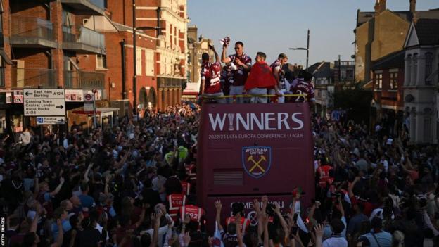 West Ham players celebrate on the open top bus