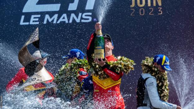 James Calado celebrates Ferrari's comeback win at Le Mans by spraying champagne skywards