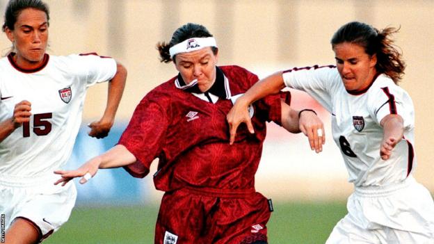 United States' Tisha Venturini and Brandi Chastain battle England's Gillian Coultard for the ball during their May 9, 1997