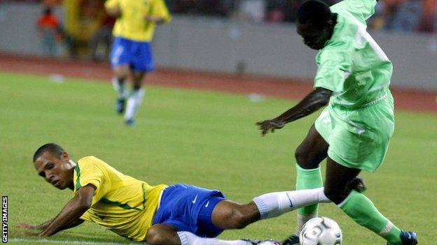Brazil's Luis Fabiano challenges John Utaka of Nigeria