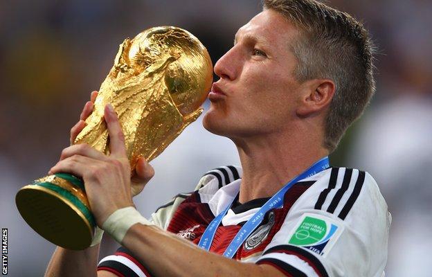 Bastian Schweinsteiger of Germany kisses the World Cup trophy in 2014
