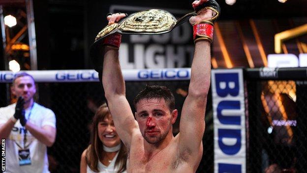 Brendan Loughnane holds the PFL featherweight title aloft