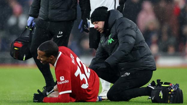 Joel Matip getting treatment by a physio on his knee injury