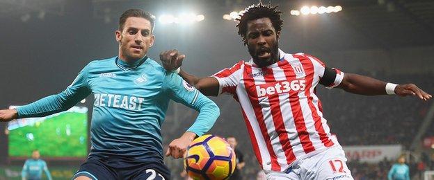 Wilfried Bony challenges Swansea City's Angel Rangel