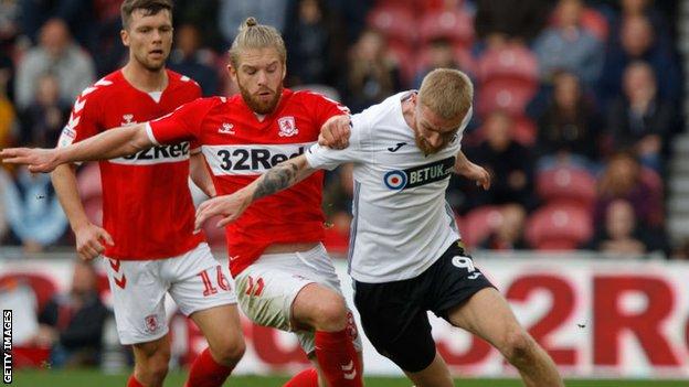 Swansea City striker Oli McBurnie battles with Middlesbrough midfielder Adam Clayton