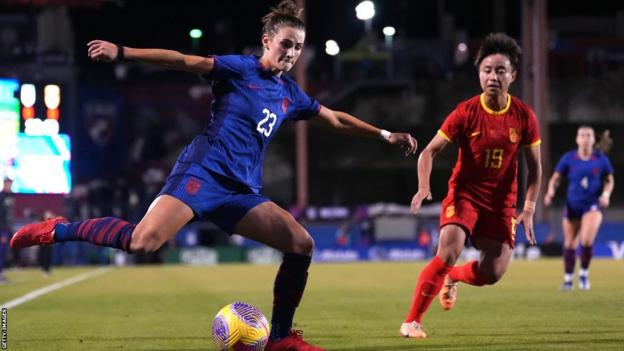 Emily Fox of the United States strikes the ball as Zhang Linyan of China defends